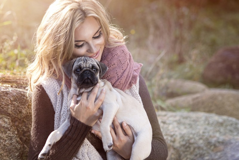 pug and woman hugging